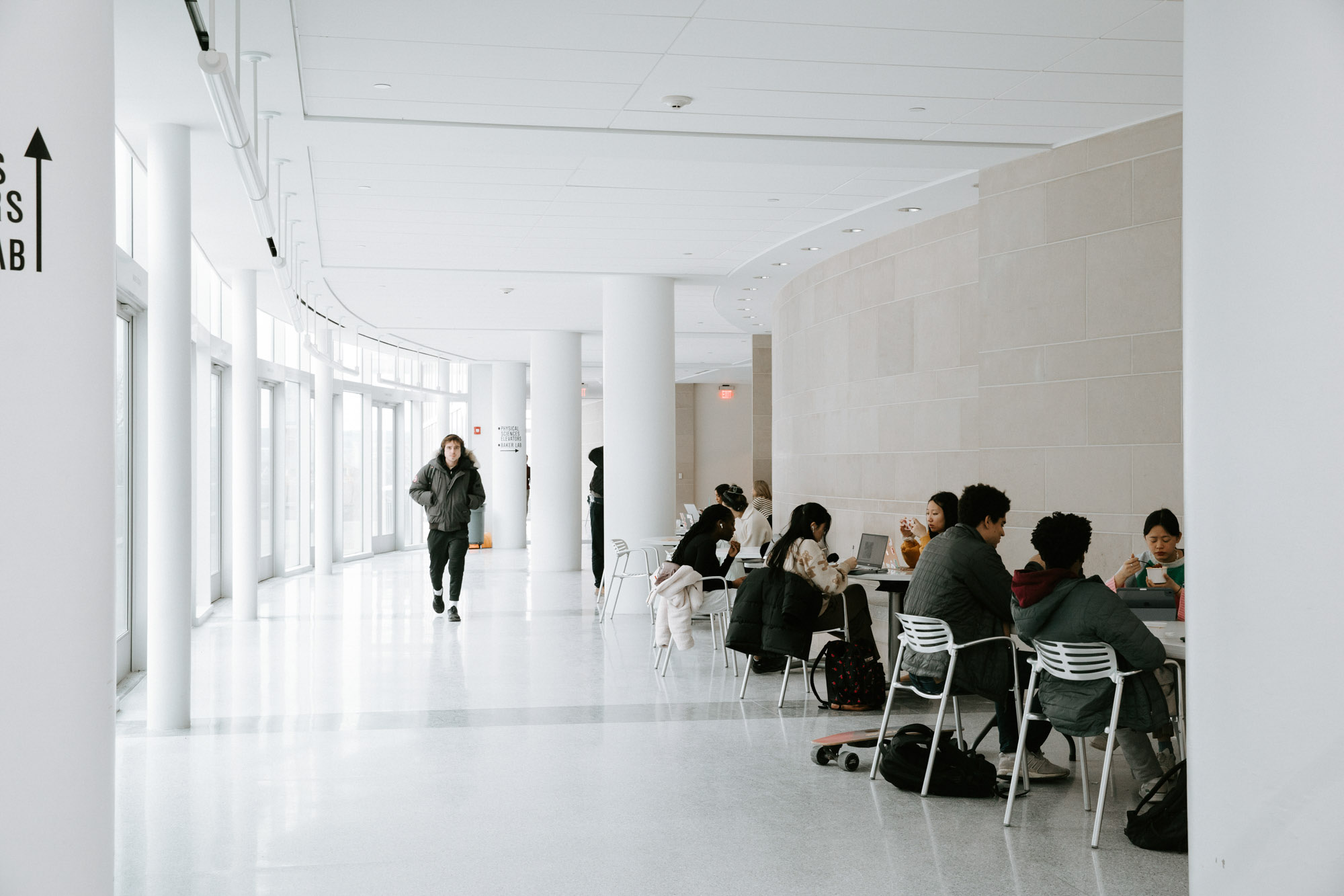 A student walks along the hallway in the Physical Sciences Building