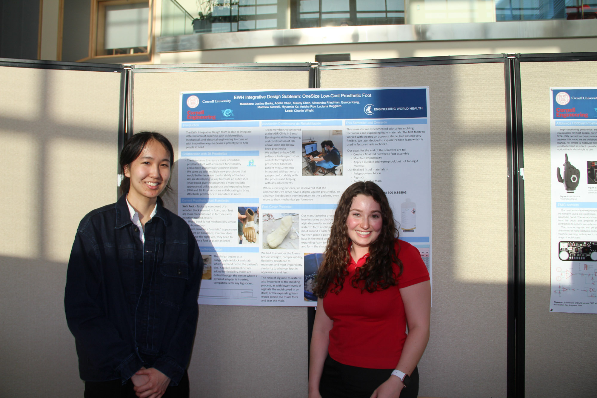 Two students from the Cornell University Engineering World Health project team standing in front of their poster at the annual project teams banquet