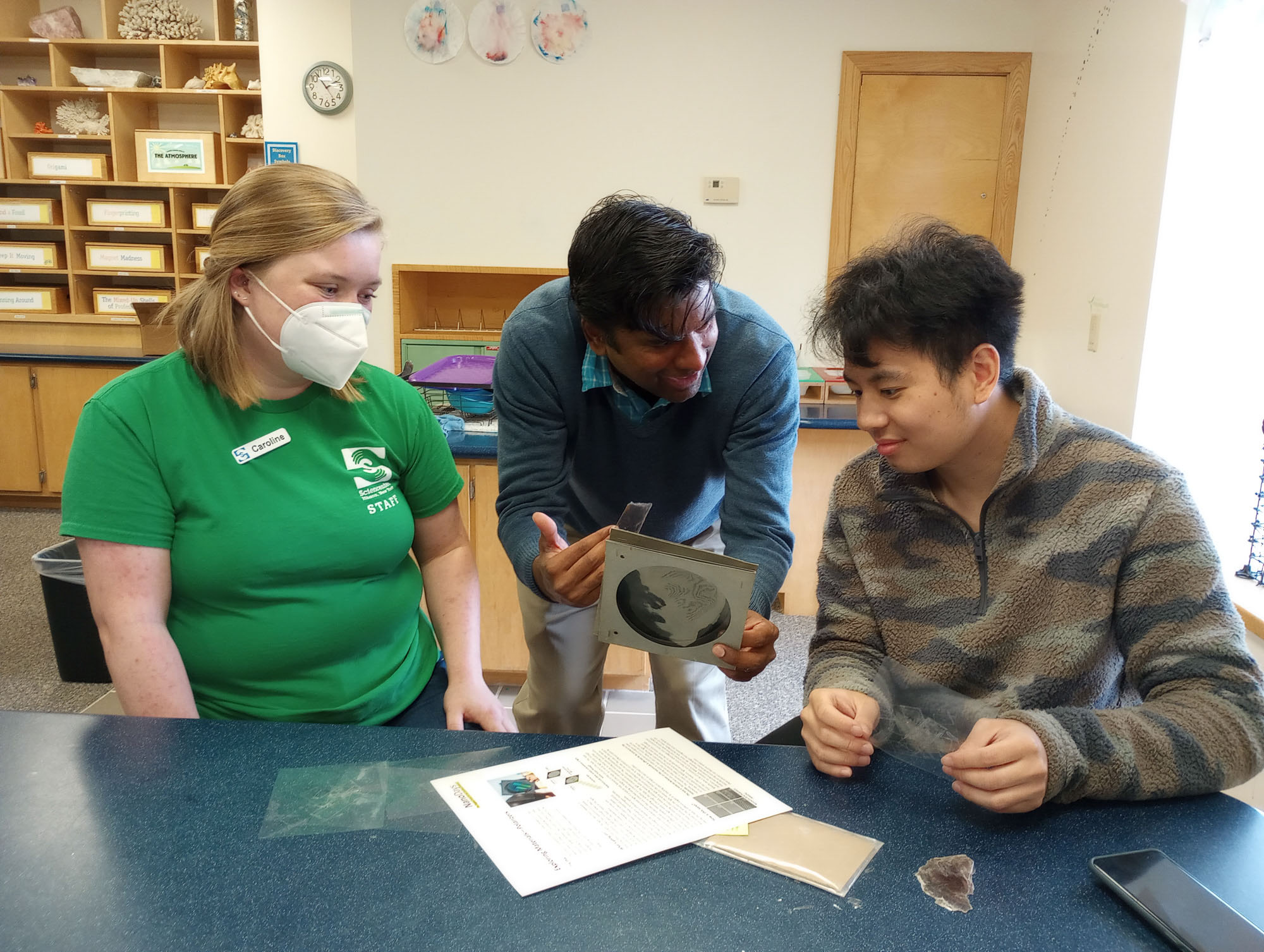 An Ithaca Sciencenter staff member and two students from the Engineering Communications minor interact in the learning lab
