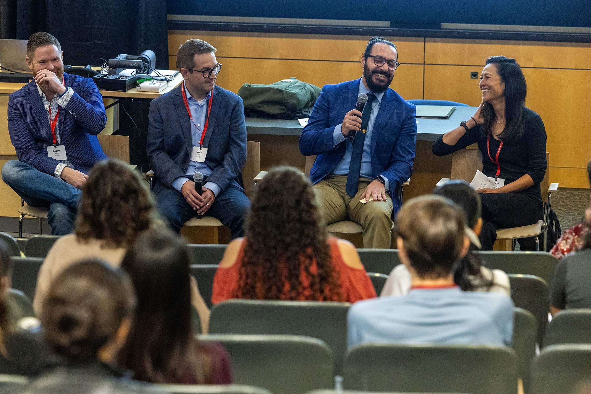 Alumni panelists Robby Bowles, Jason Long; Nashaat Rasheed; and Sharon Wong sit together, share career reflections and laugh.