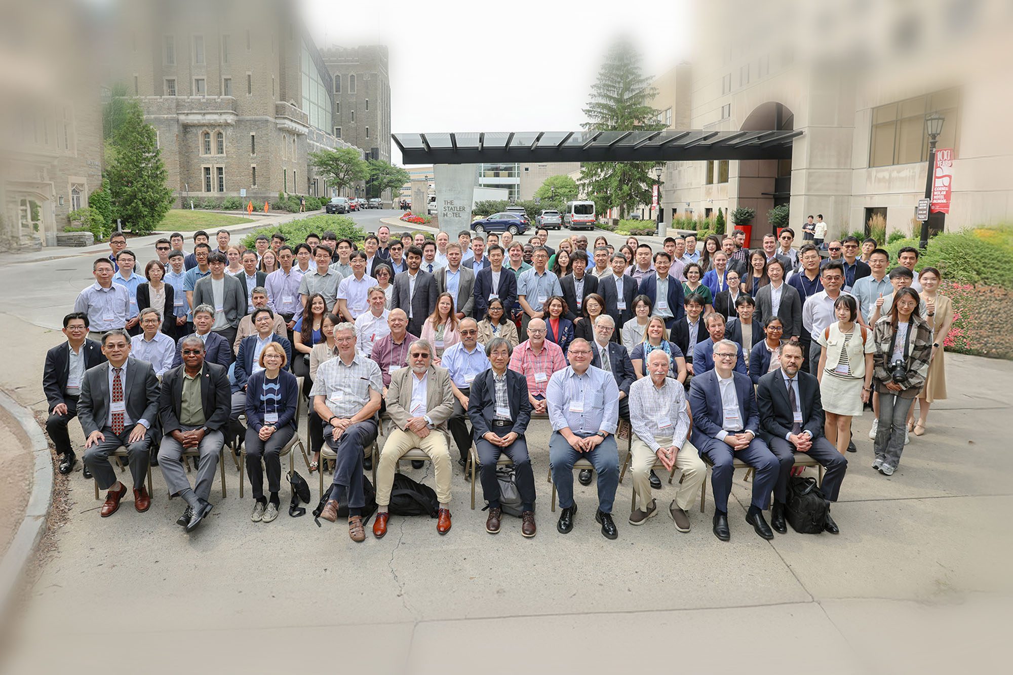 Conference attendees sit together outside the Statler Hotel.