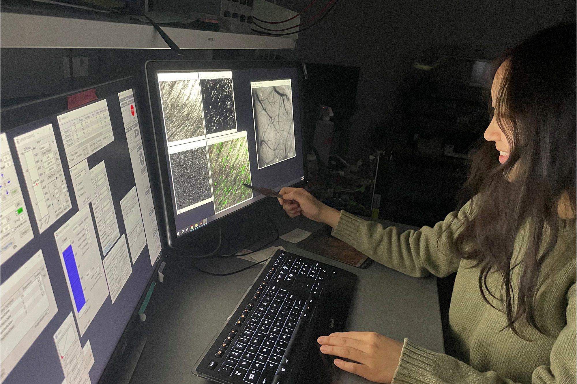 Schaffer-Nishimura lab undergraduate researcher Nuri Hong looks at neuron imaging on computer.