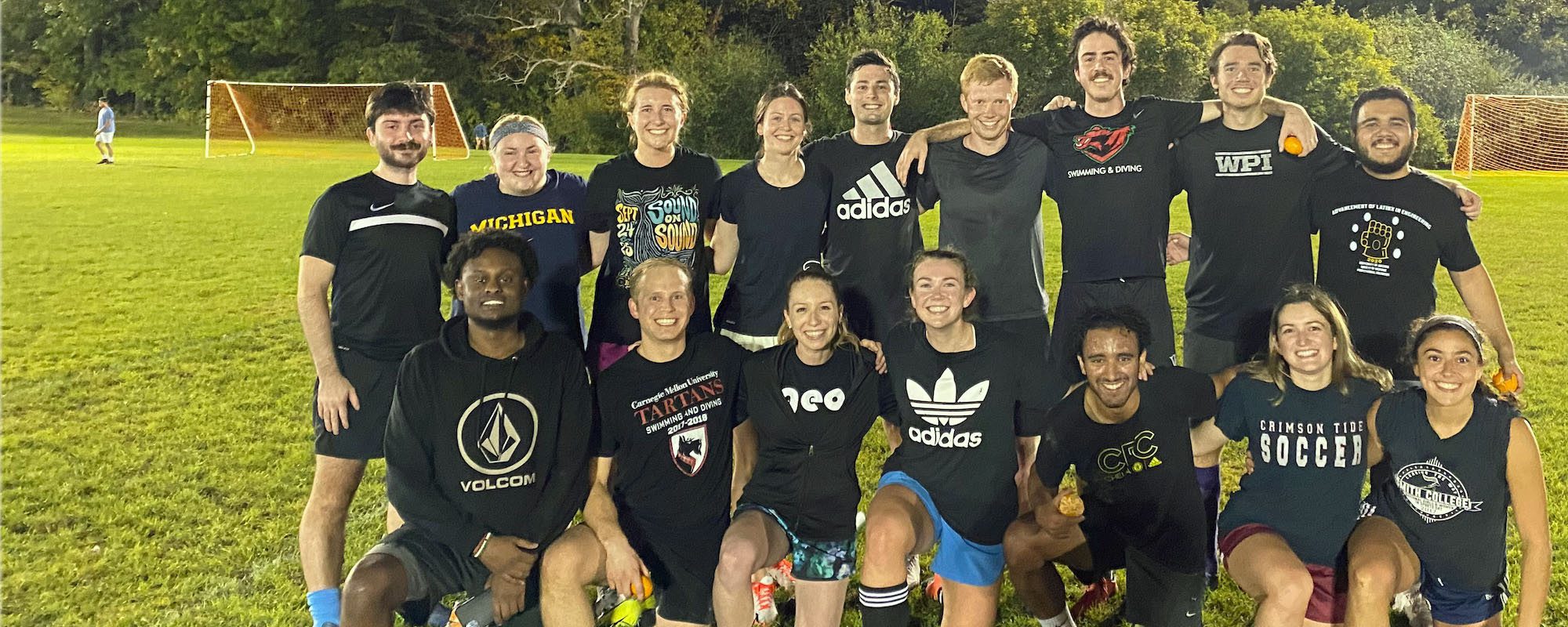 Graduate student soccer team standing together on field
