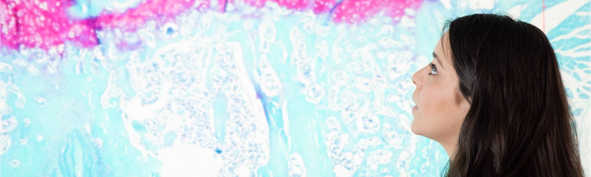 Student looking at bone research image on presentation screen.