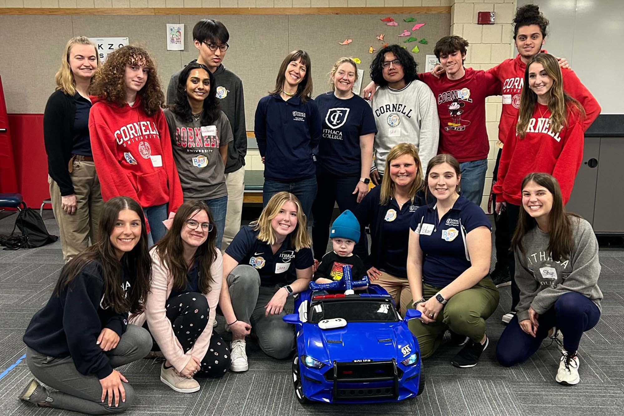 Undergraduate students and faculty work together to build a car for toddlers with mobility challenges at GoBbabyGo event at IC.