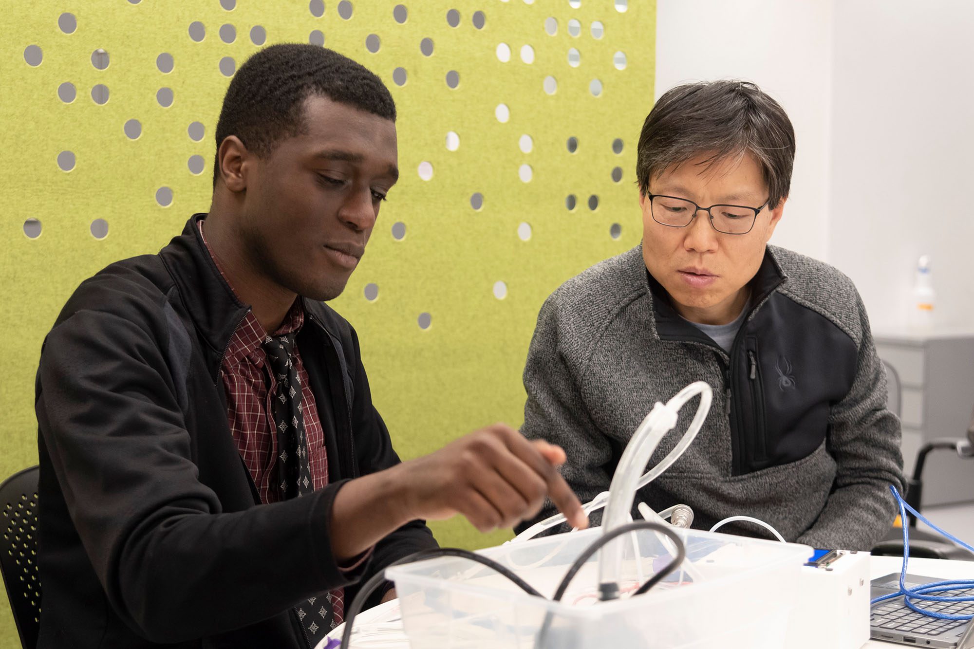 Professor Yadong Wang works with a student in the lab.