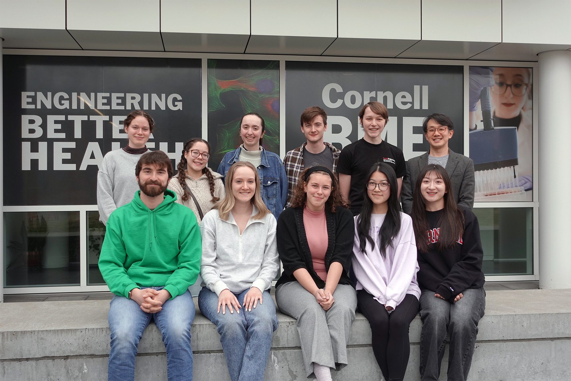BMES graduate student group leadership sits together outside Weill Hall.