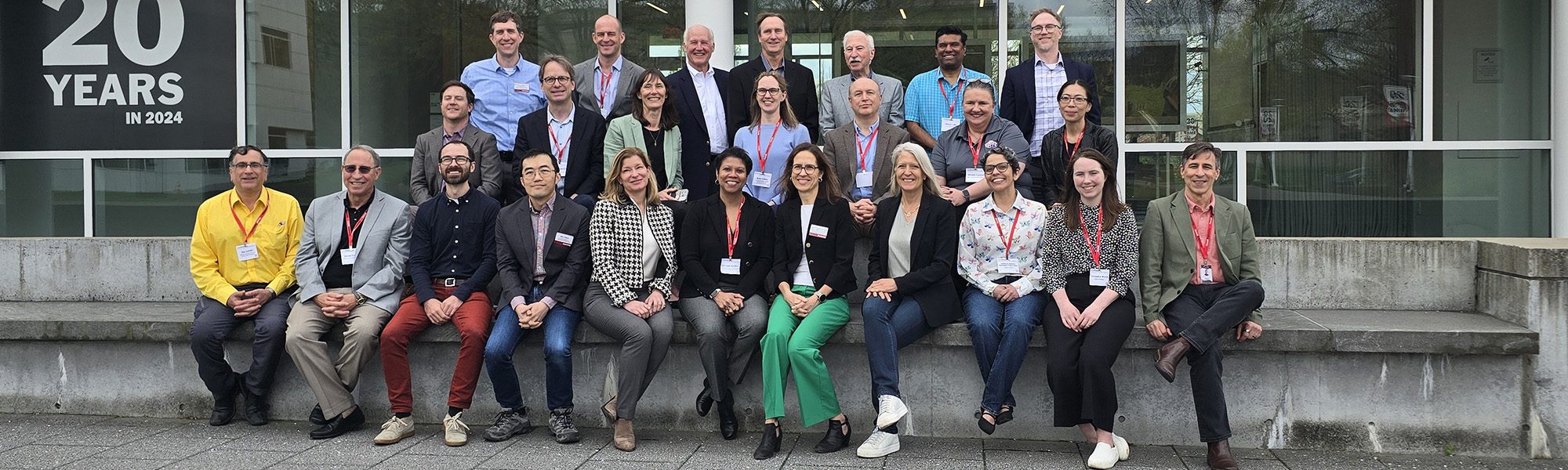 Advisory council stands together on lawn outside Weill Hall