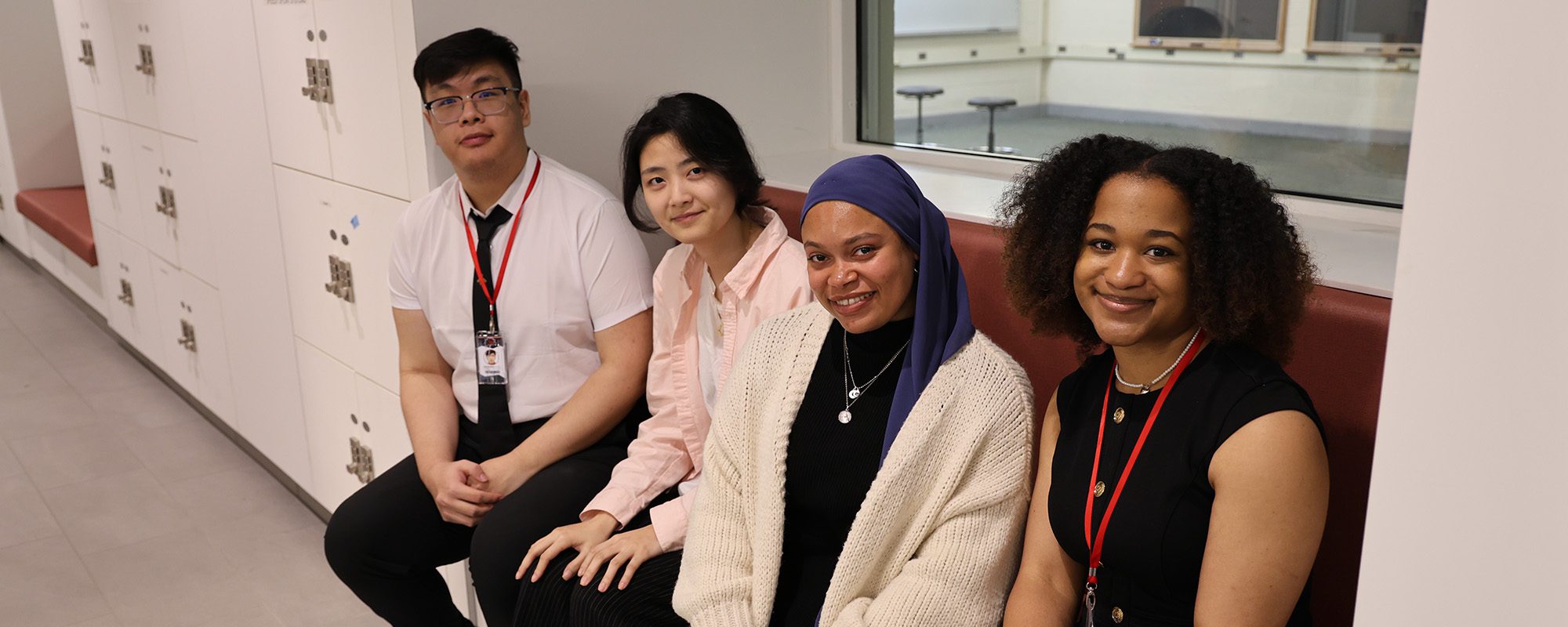 An M.Eng. design team sits together on a Tang Hall bench.