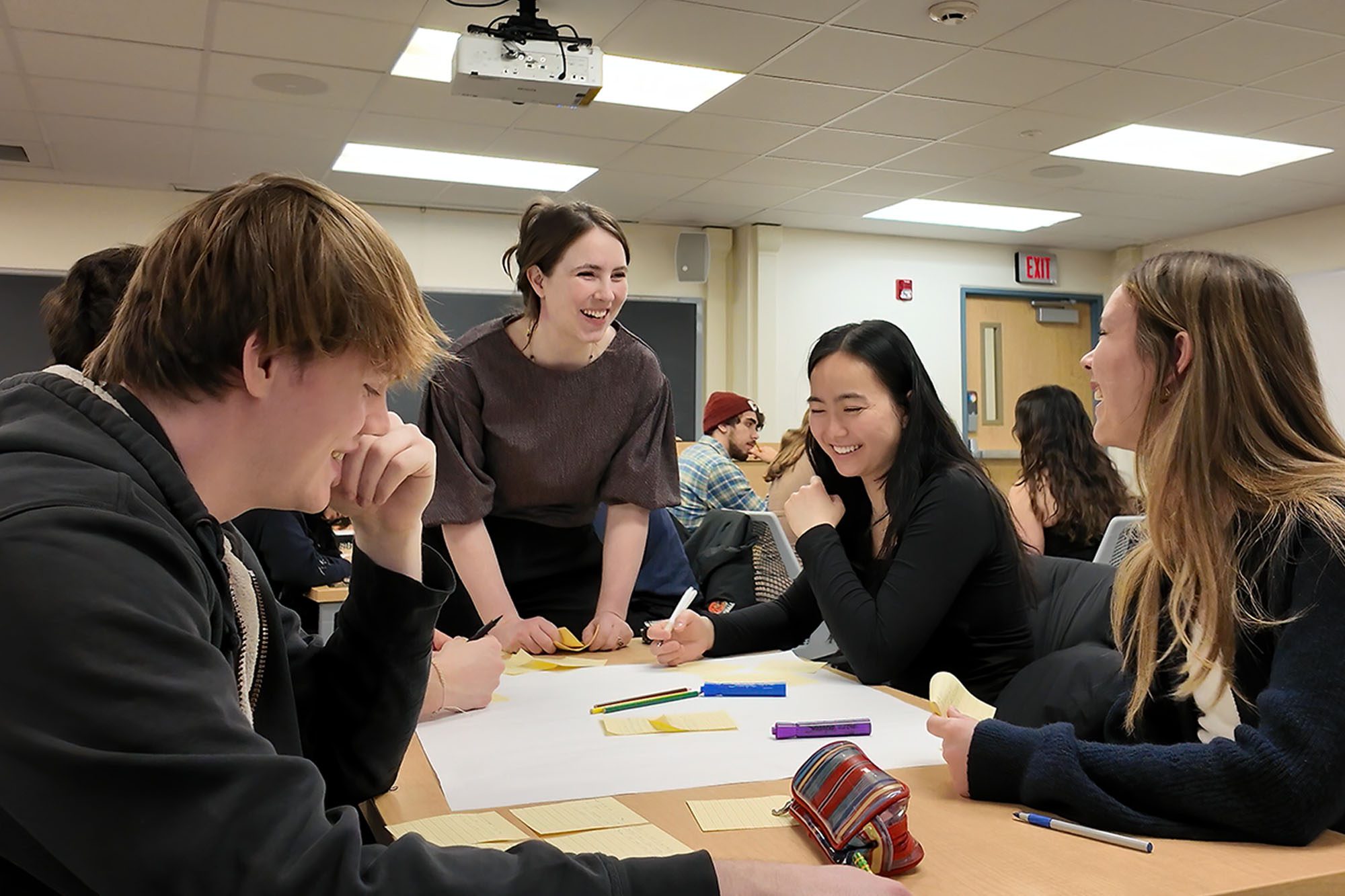Alex Werth chats with undergraduate students in the engineering education research EER classroom.