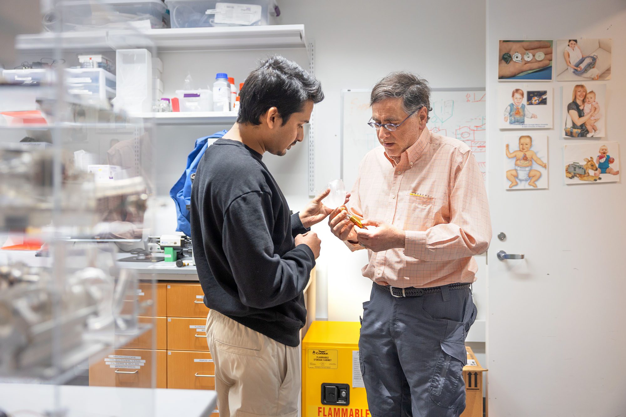 James Antaki and student in lab holding the pediaflow pediatric heart device.