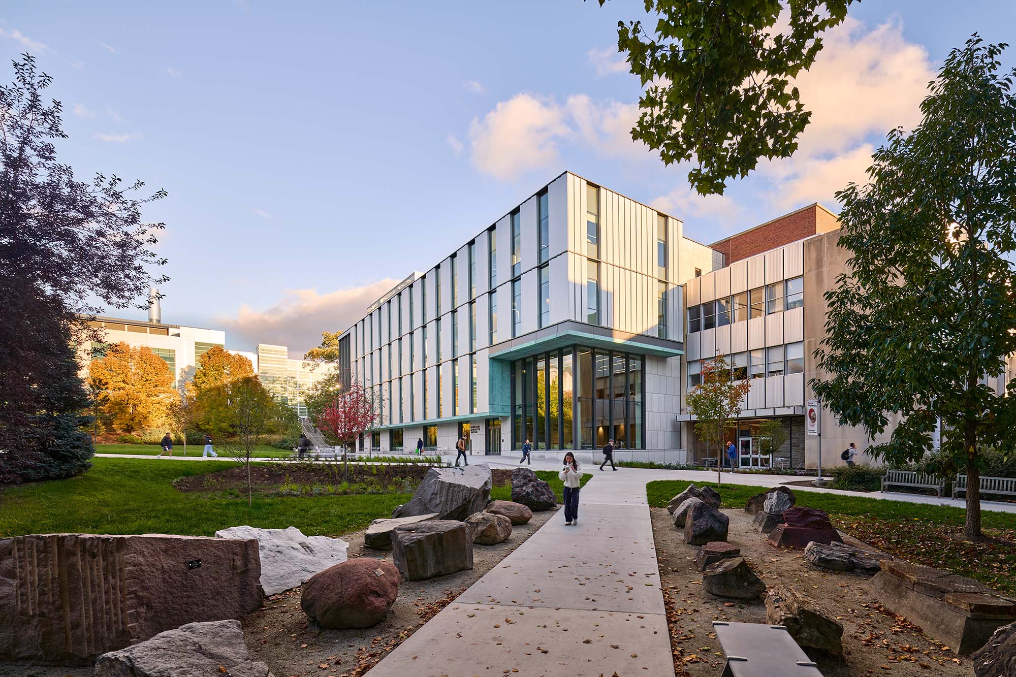Tang Hall exterior from rock garden sidewalk in fall.