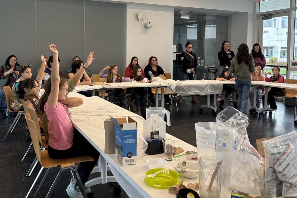 Girl scouts and graduate students work together at table in Weill Hall doing engineering experiments for girl scout engineering day (GSED) 2025.