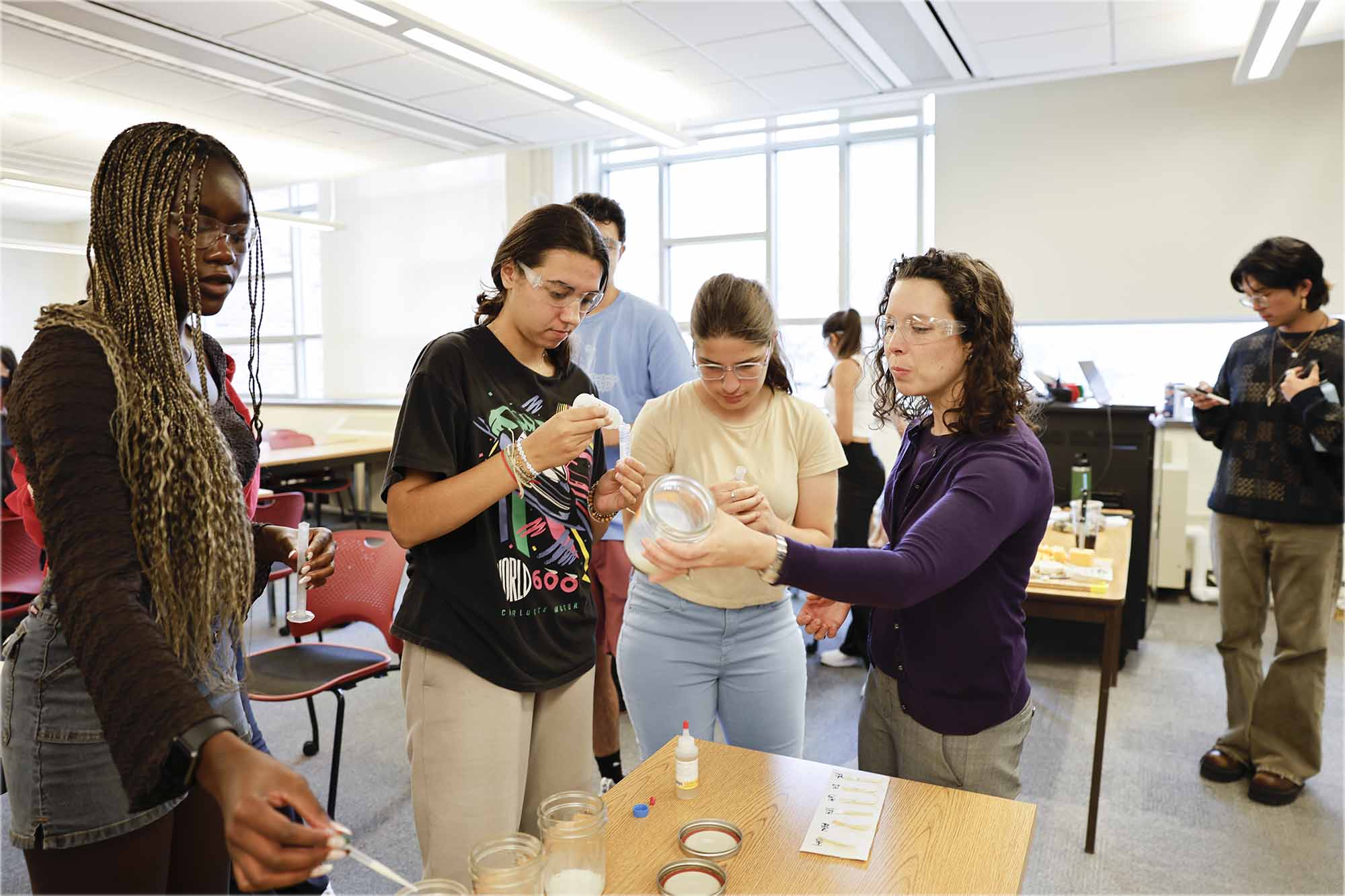 Allison Godwin works with students to label bottles in an Engineering education research EER classroom.