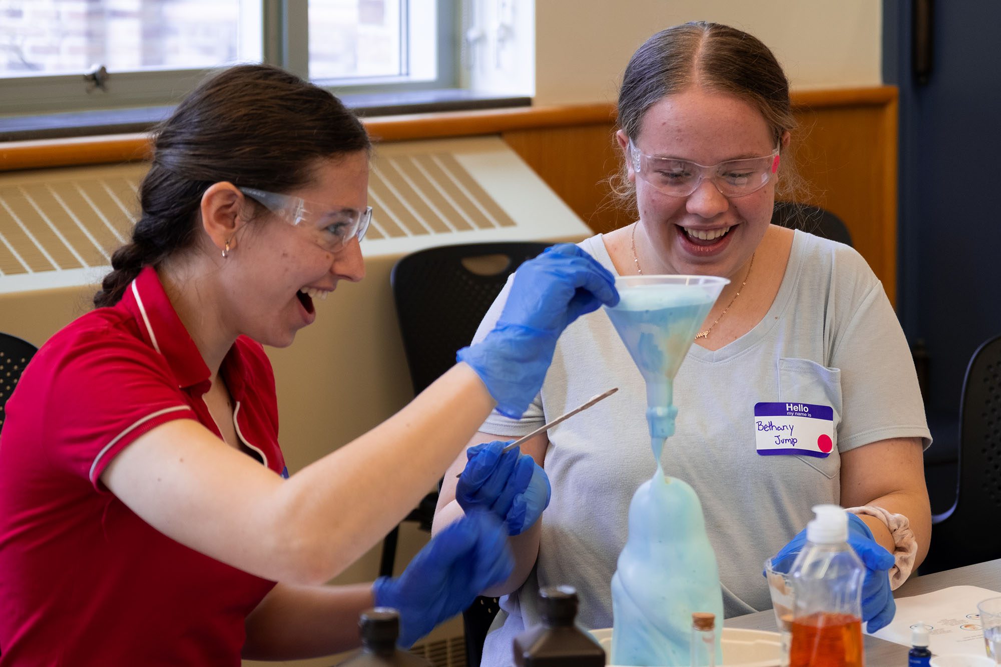 Students perform an experiment with foam and funnels in Olin Hall.