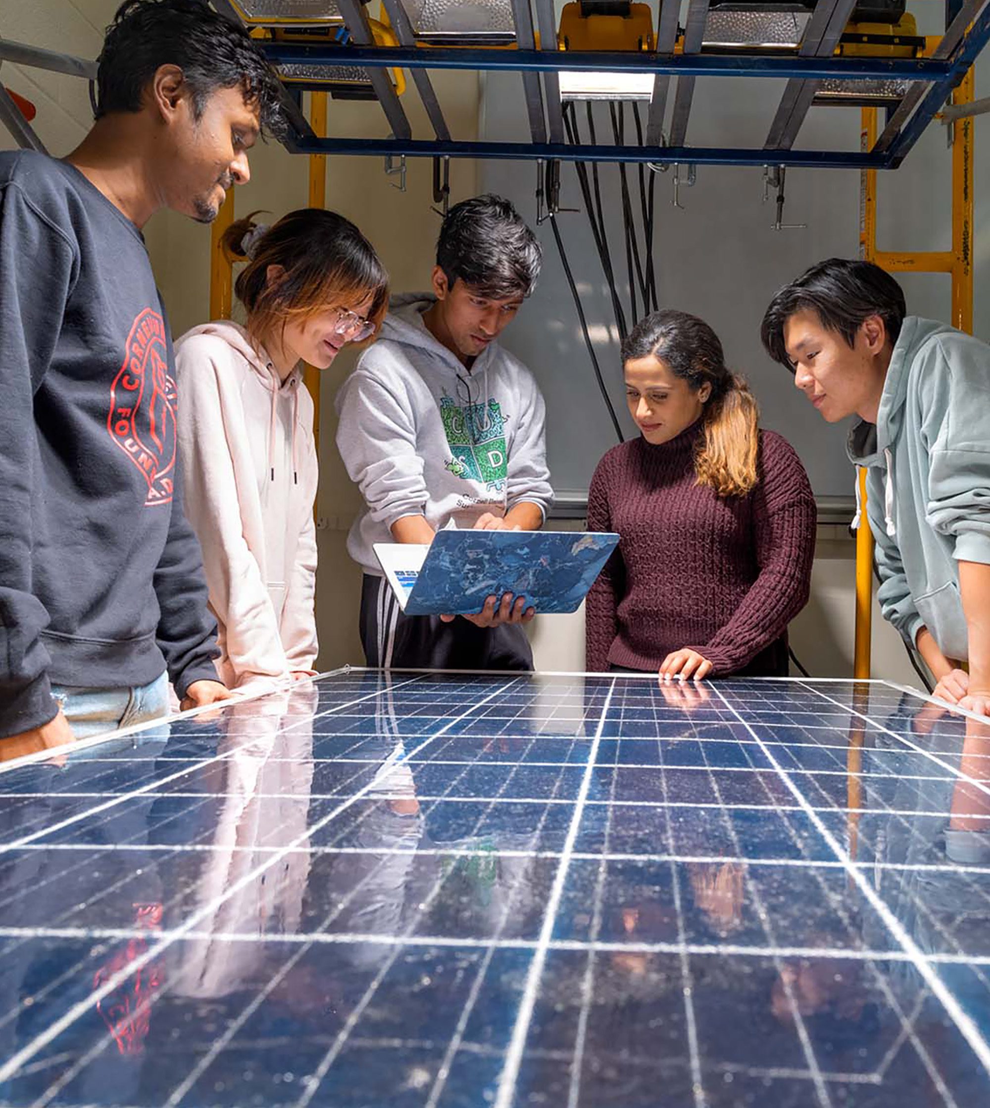 M.Eng. students work together to decide how to refurbish one of the Solar Panel Reboot team’s broken photovoltaic boards.