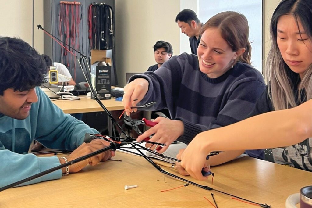 Julia Salatti with peers in a bioengineering capstone design class re-engineering an umbrella into a water collection device.