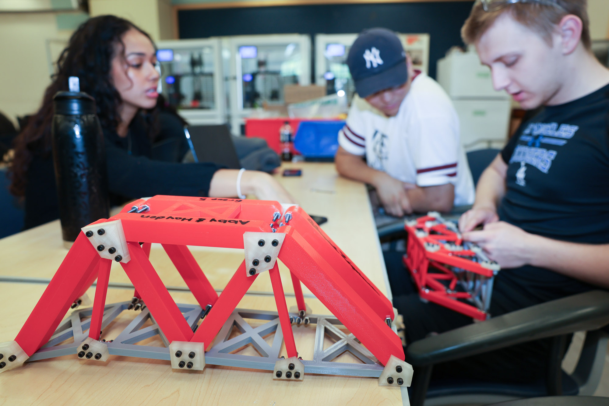 Three students working in professor Ramya Nair's bridge testing class