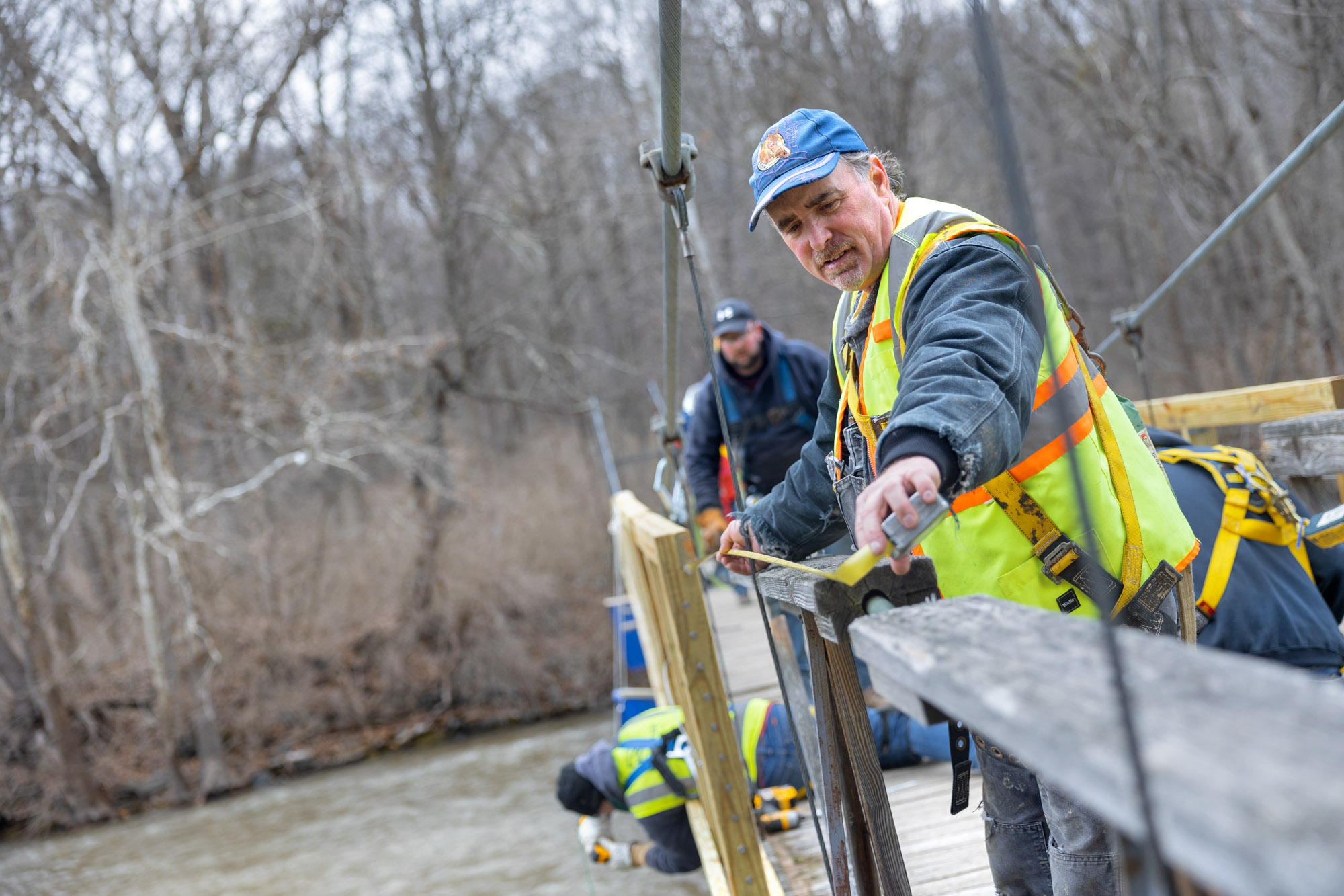 Students and local volunteers renovate the flat rock pedestrian bridge