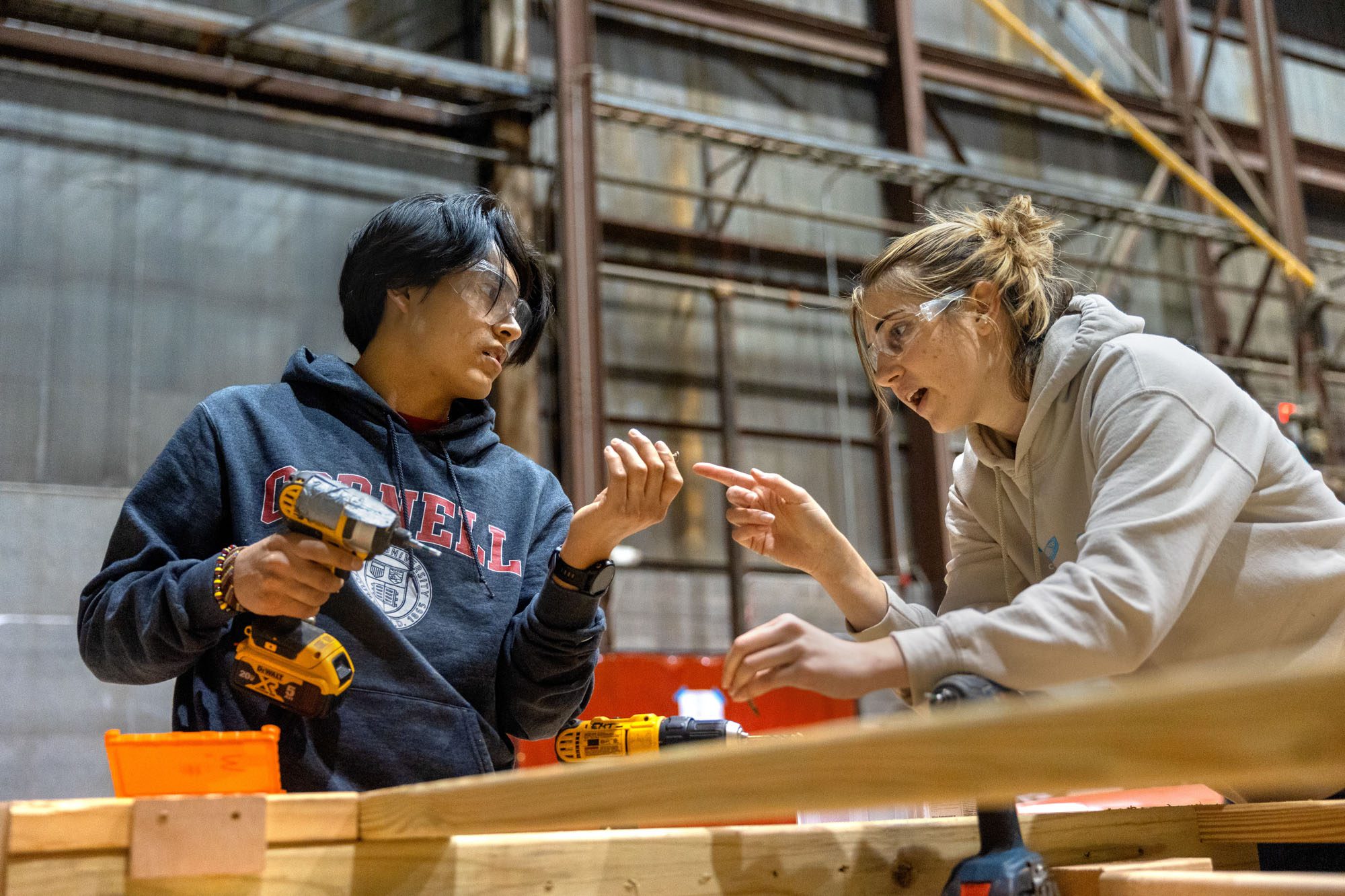 two students work on a bridge
