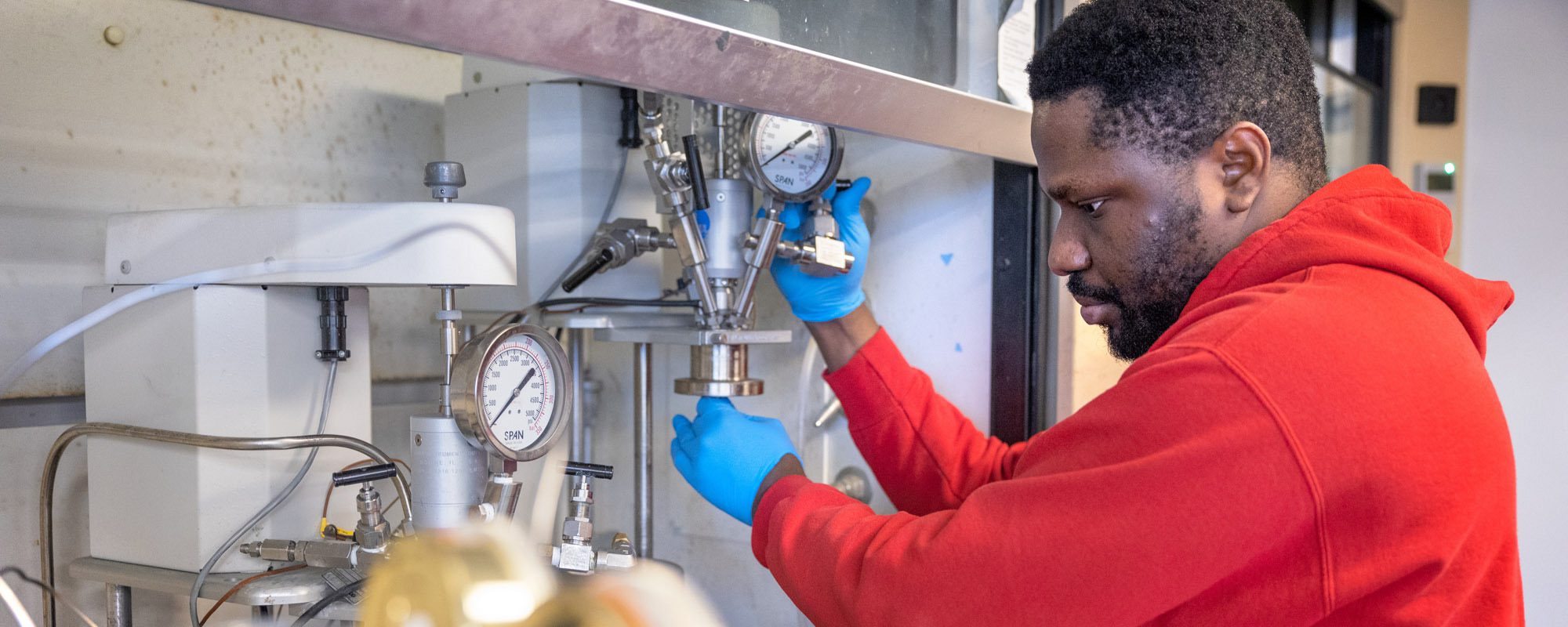 Engineering Ph.D. candidate Prince Ochonma works in a lab in Hollister Hall.