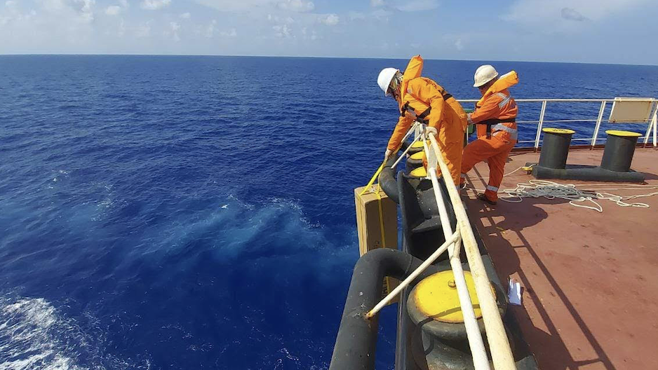 Crewmembers on a research vessel deploy ARGO tools.