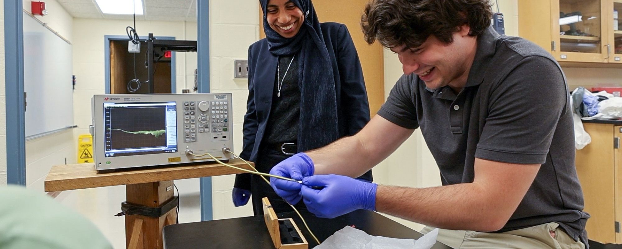 Amal El-Ghazaly working with a student in her lab on magnetic sensors