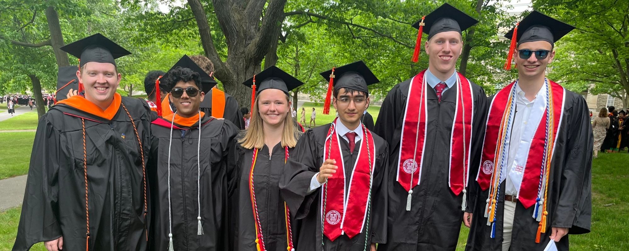 ECE students standing outside in graduation regalia during 2024 commencement