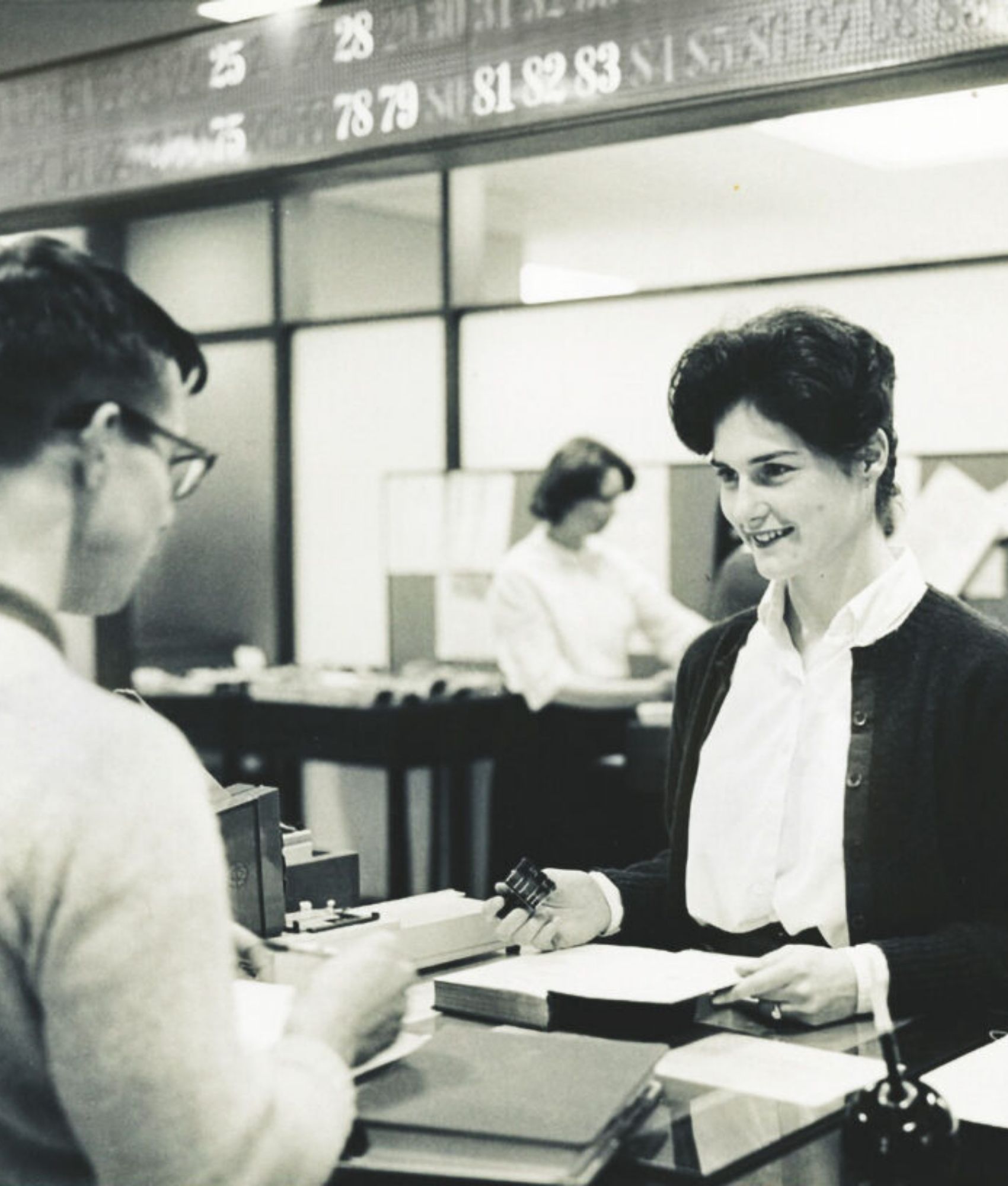 Olin Library circulation desk with the call board in the background.