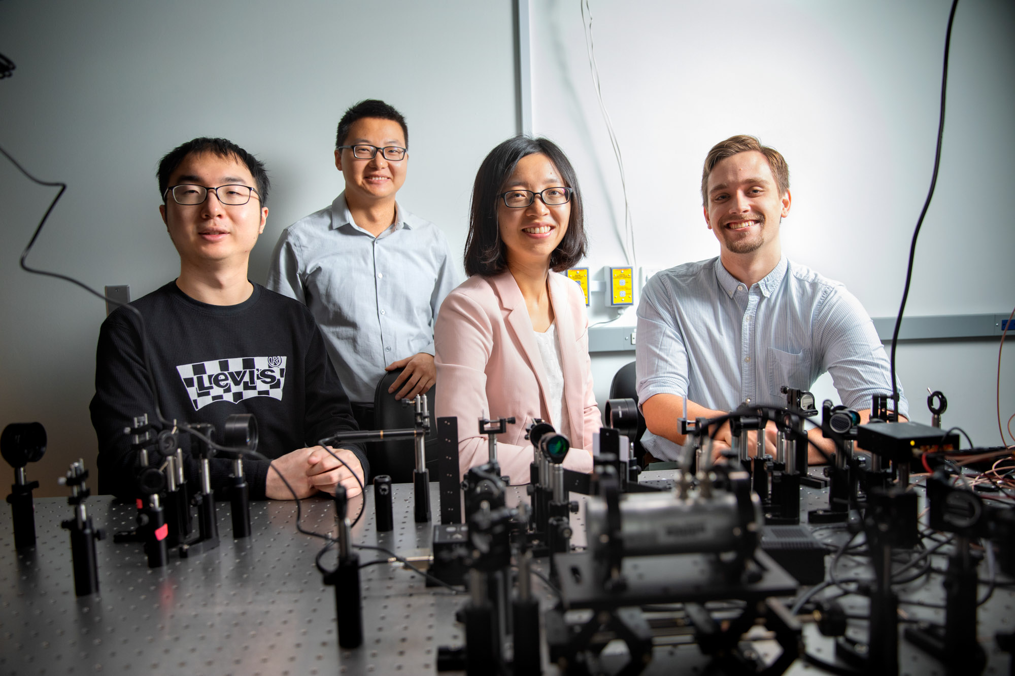 Zhiting Tian in her Upson Hall lab with Chen Li, Hao Ma, and Zach Rouse.