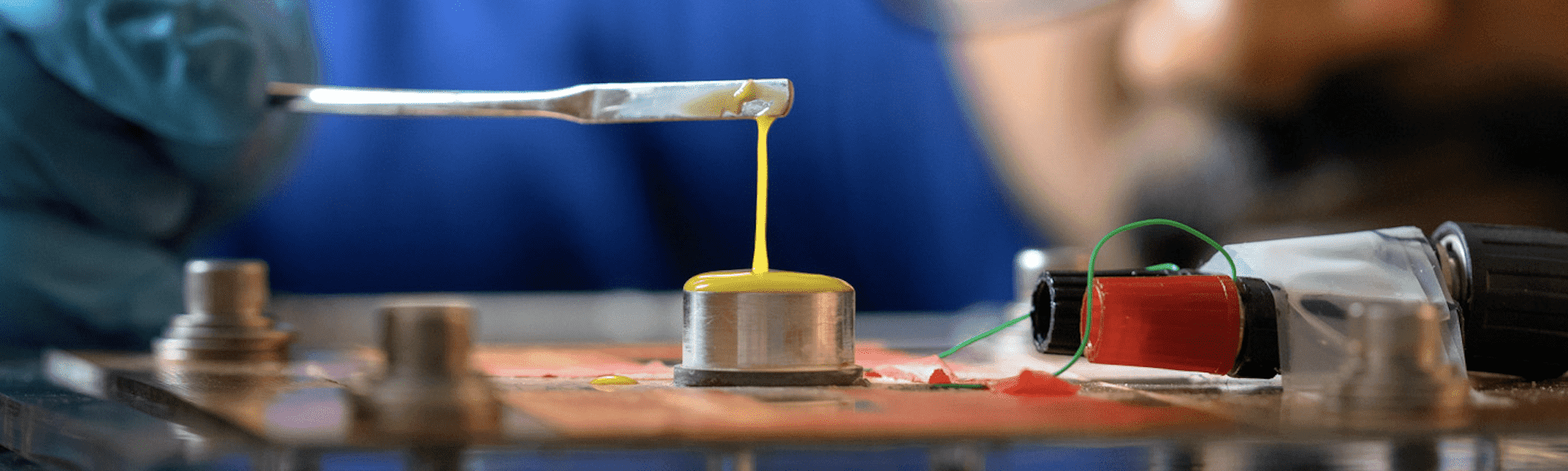 yellow material stretching between a base and an instrument.