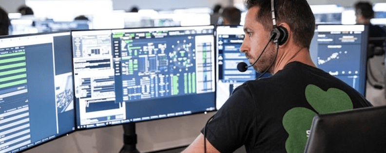 Kris Young of SpaceX sits at a control panel.
