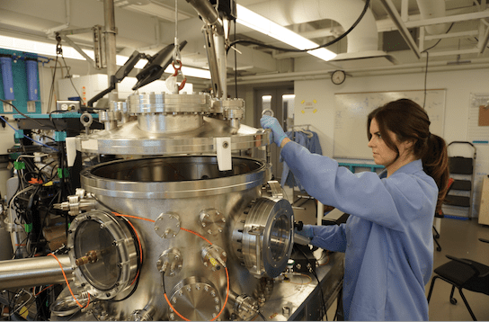 Ph.D. student Giuliana Hofheins with a high-tech chamber used in her research.