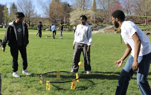 Three students play a game on the Pew Engineering quad.