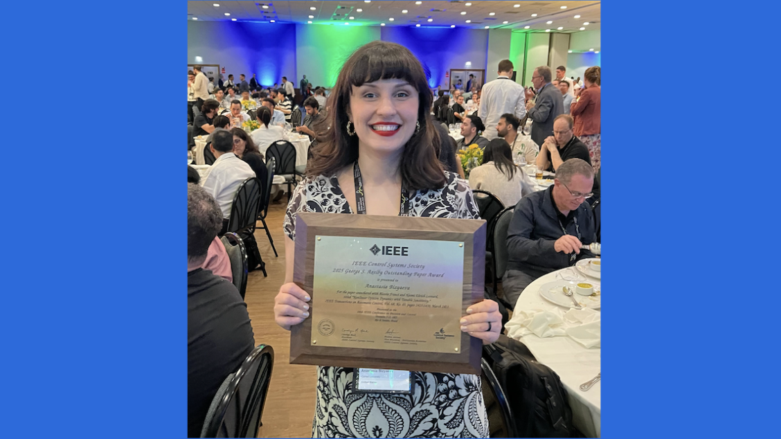 Anastasia Bizyaeva holds the plaque she was given to recognize her Axelby award at an IEEE conference in December, 2025.