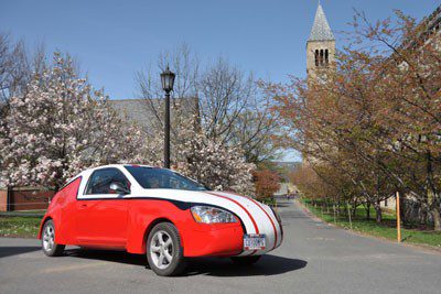 The Cornell100+ MPG car parked on the Cornell campus with McGraw Tower in the background