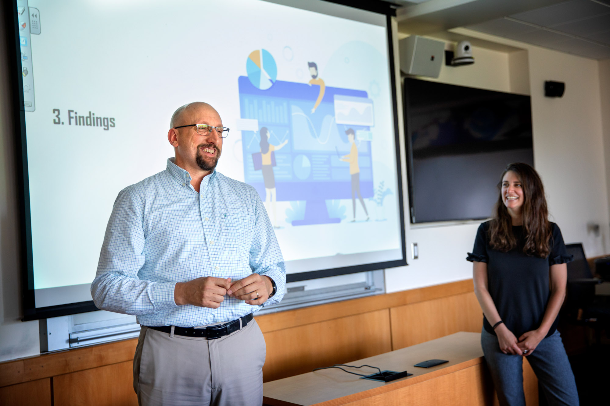 senior lecturer Robert Newman and engineering management executive director Andrea Ippolito speaking in front of a classroom