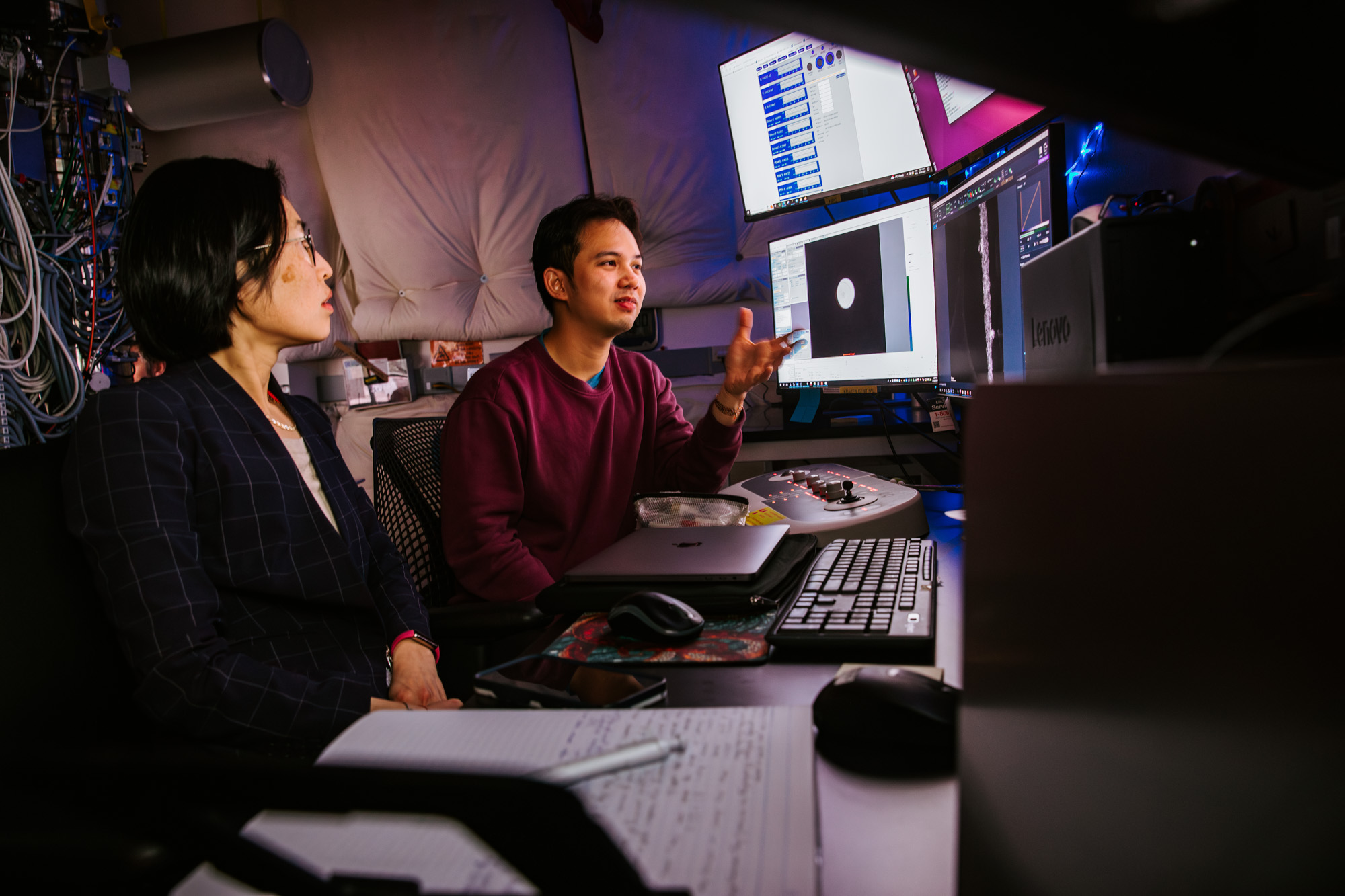 Professor Judy Cha working with a student in front of 4 display monitors in her research lab