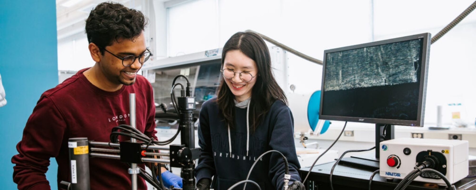 Two students in a materials science and engineering lab with equipment