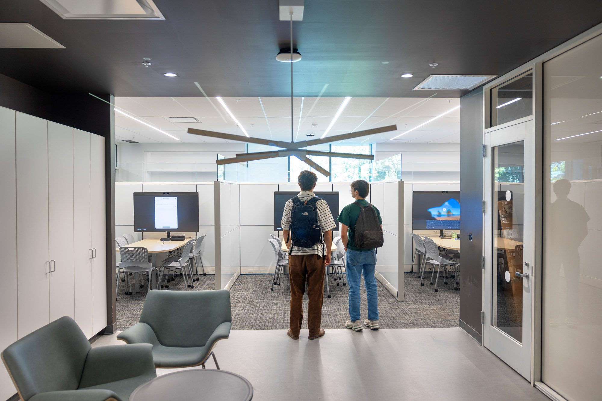 Students gathering at tables in a shared study space in Tang Hall.