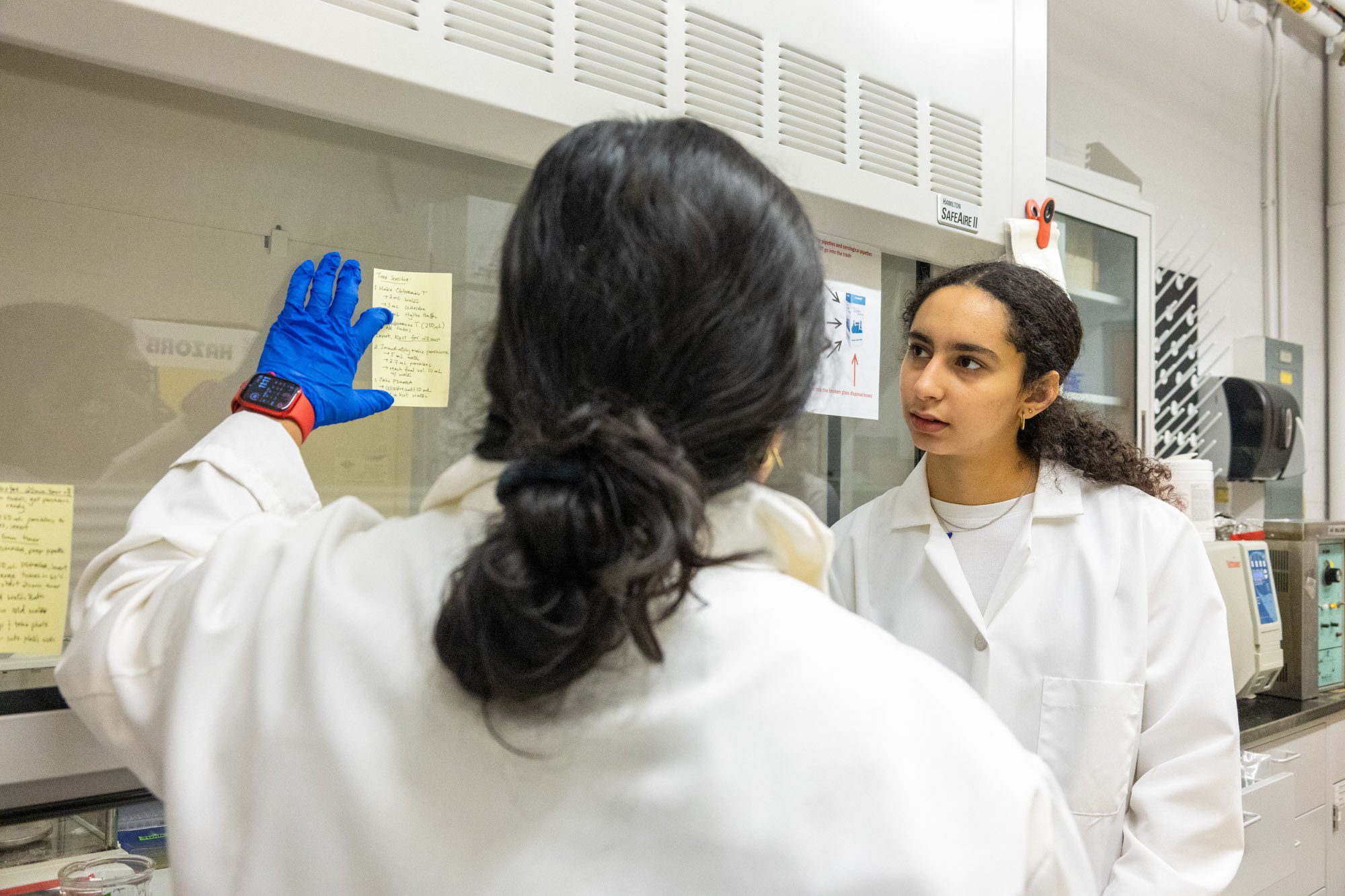 Zaina and Asher review the steps for an experiement