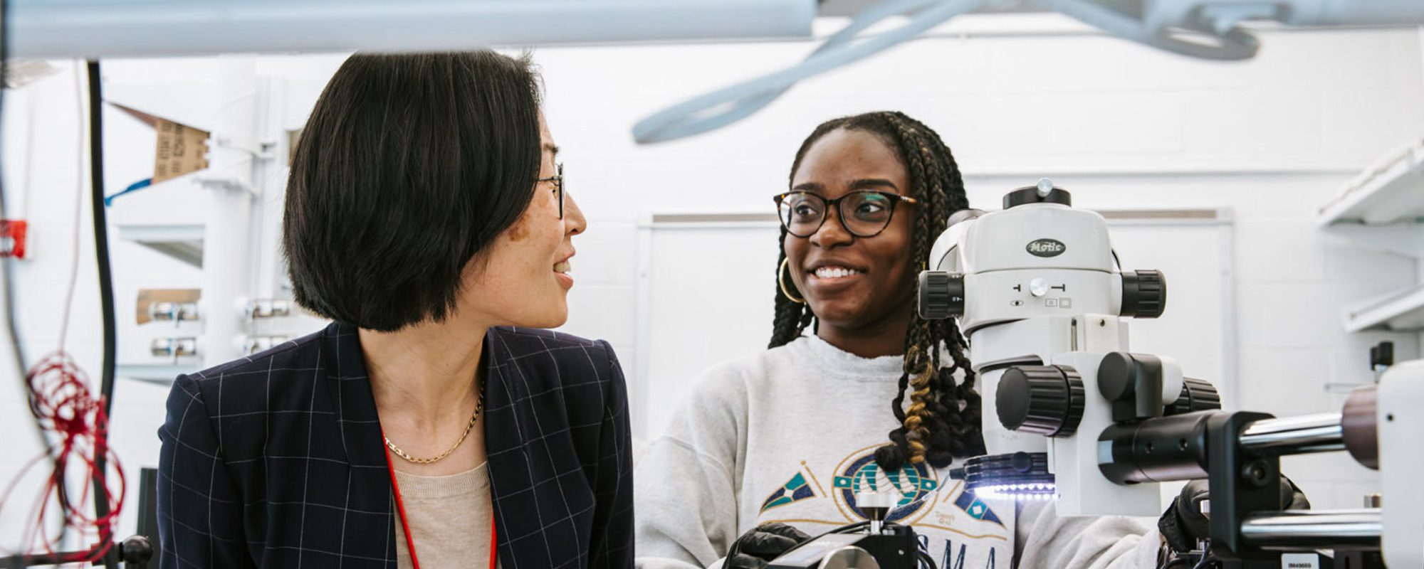 Female student smiling with lab equipment