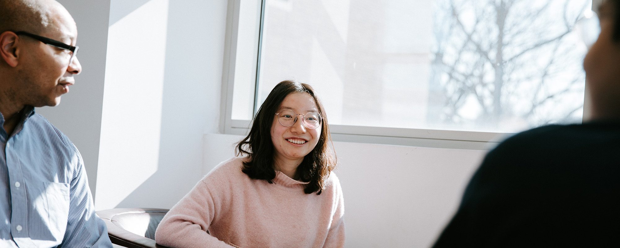 Mark Lewis talks with two students