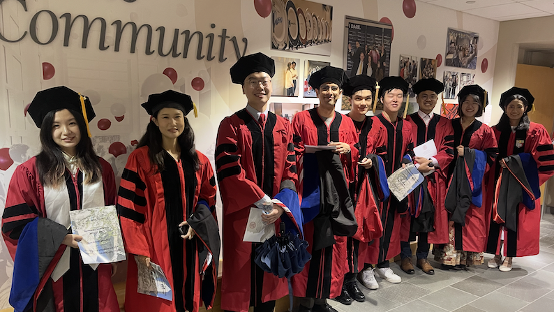 Nine students in caps and gowns lined up, waiting to enter the Statler Auditorium for the May, 2025 ORIE graduation ceremony.