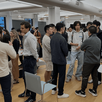 Alumni of the Cornell Financial Engineering Manahttan program stand and mingle.