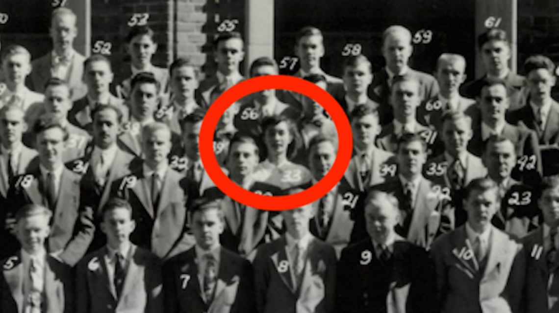 black and white group photo with red circle around a woman