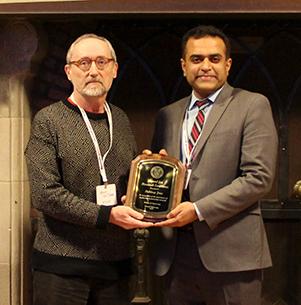 Debdeep Jena receives his award from MSE Professor Bruce van Dover