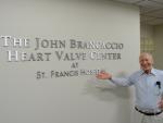 John Brancaccio poses in front of a sign bearing his name at St. Francis Hospital