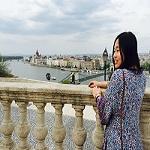 Peggy Hsu stands on a  bridge in Budapest