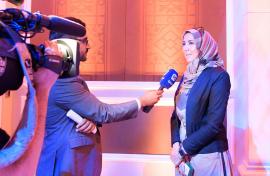 Bayan Alturkestani being interviewed on stage